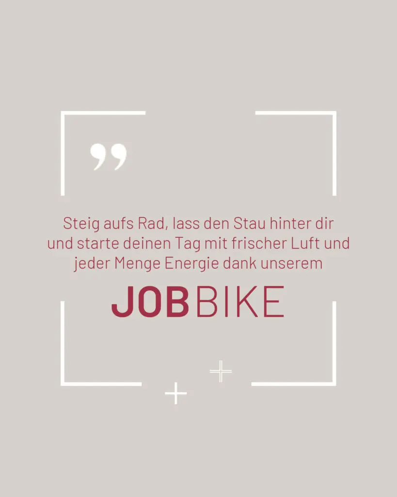 Eine deutsche Textgrafik mit einem Zitat: „Steig aufs Rad, lass den Stau hinter dir und starte deinen Tag mit frischer Luft und jeder Menge Energie dank unserem JOBBIKE“ in Rot und Grau auf beigem Hintergrund mit Zierlinien und Anführungszeichen.